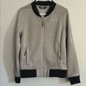 The North Face Kelana women’s bomber jacket, tan/gray with black cuffs. Size M.